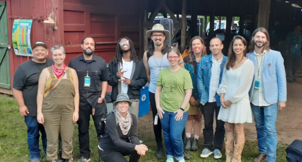 A group of singer-songwriter stand together outside the LEAF Lounging Barn.