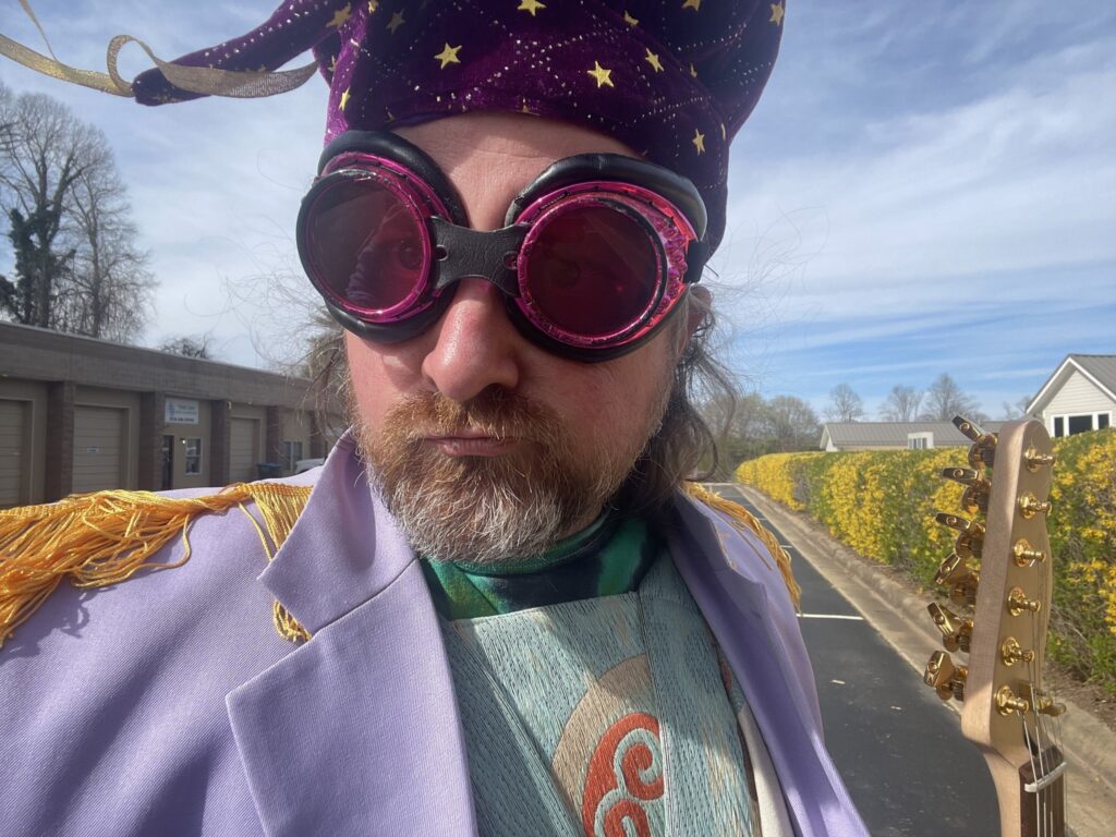 Headshot of Josh Batenhorst wearing a purple hat and goggles.