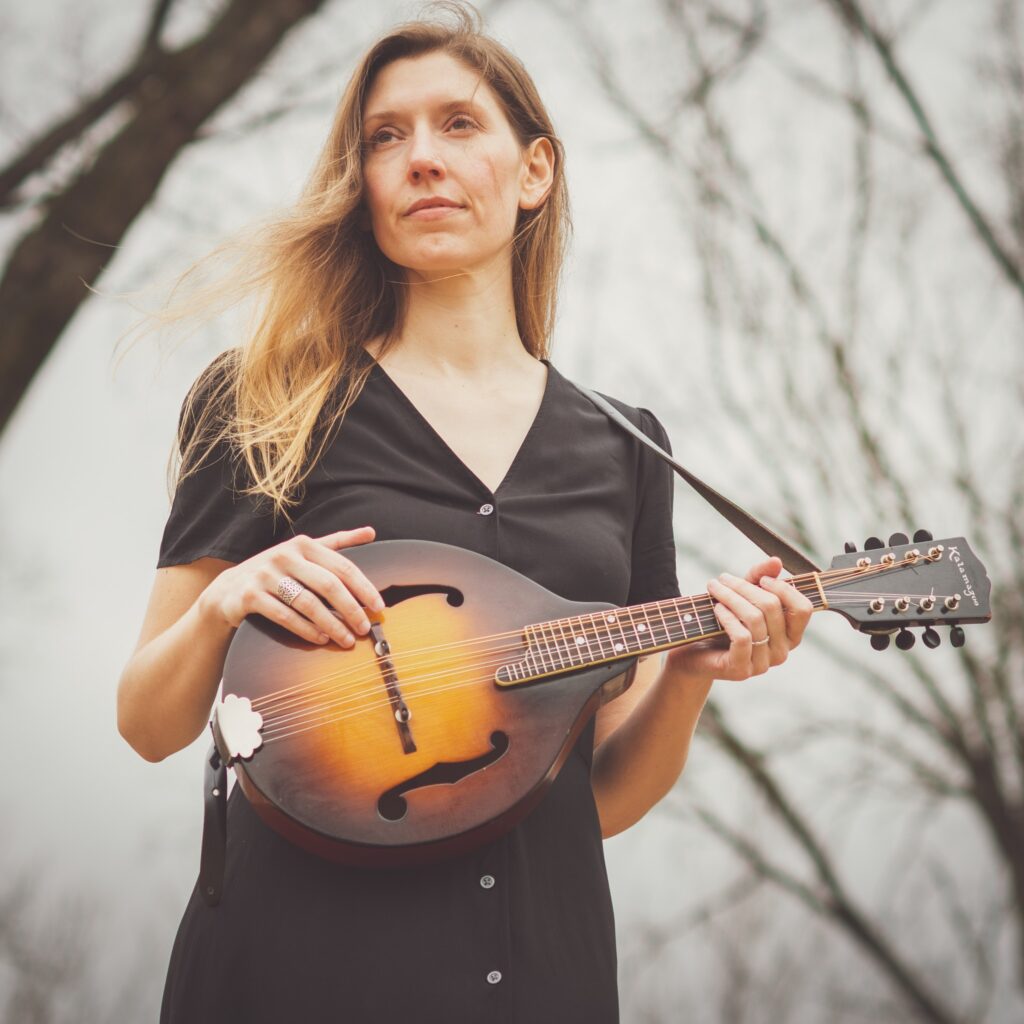 Kate Prascher holding a mandolin.