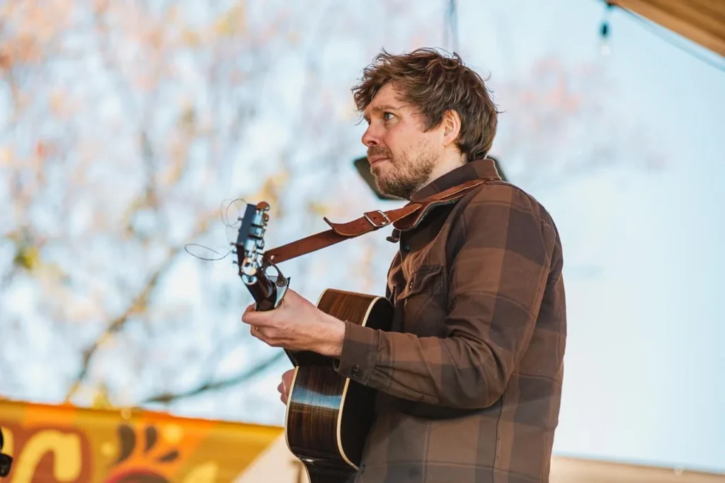 Singer-songwriter Logan Vath performs with a guitar.